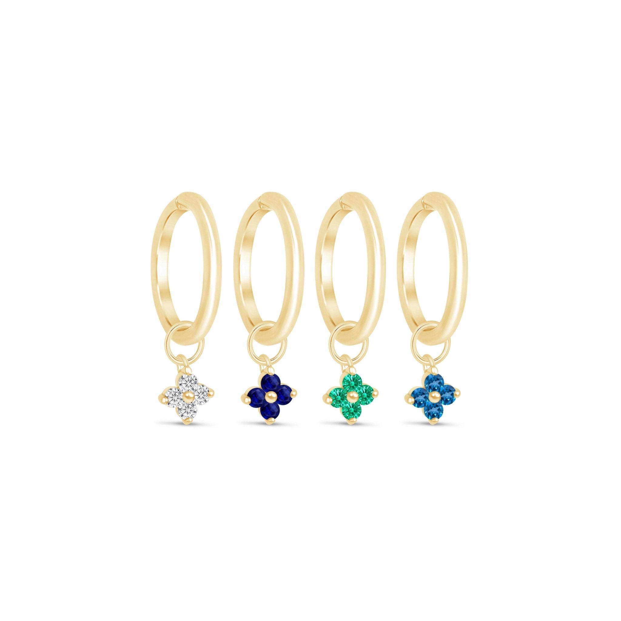 a set of four rings with different colored stones