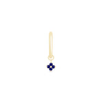 a gold earring with a blue flower