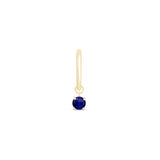 a gold earring with a blue stone