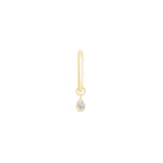 a gold earring with a single diamond