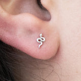 a close up of a person's ear with a snake on it