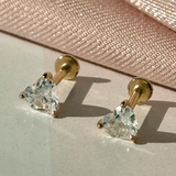 a pair of earrings sitting on top of a piece of paper