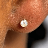 a close up of a person's ear with a diamond in it