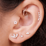 a close up of a person wearing a pair of ear piercings