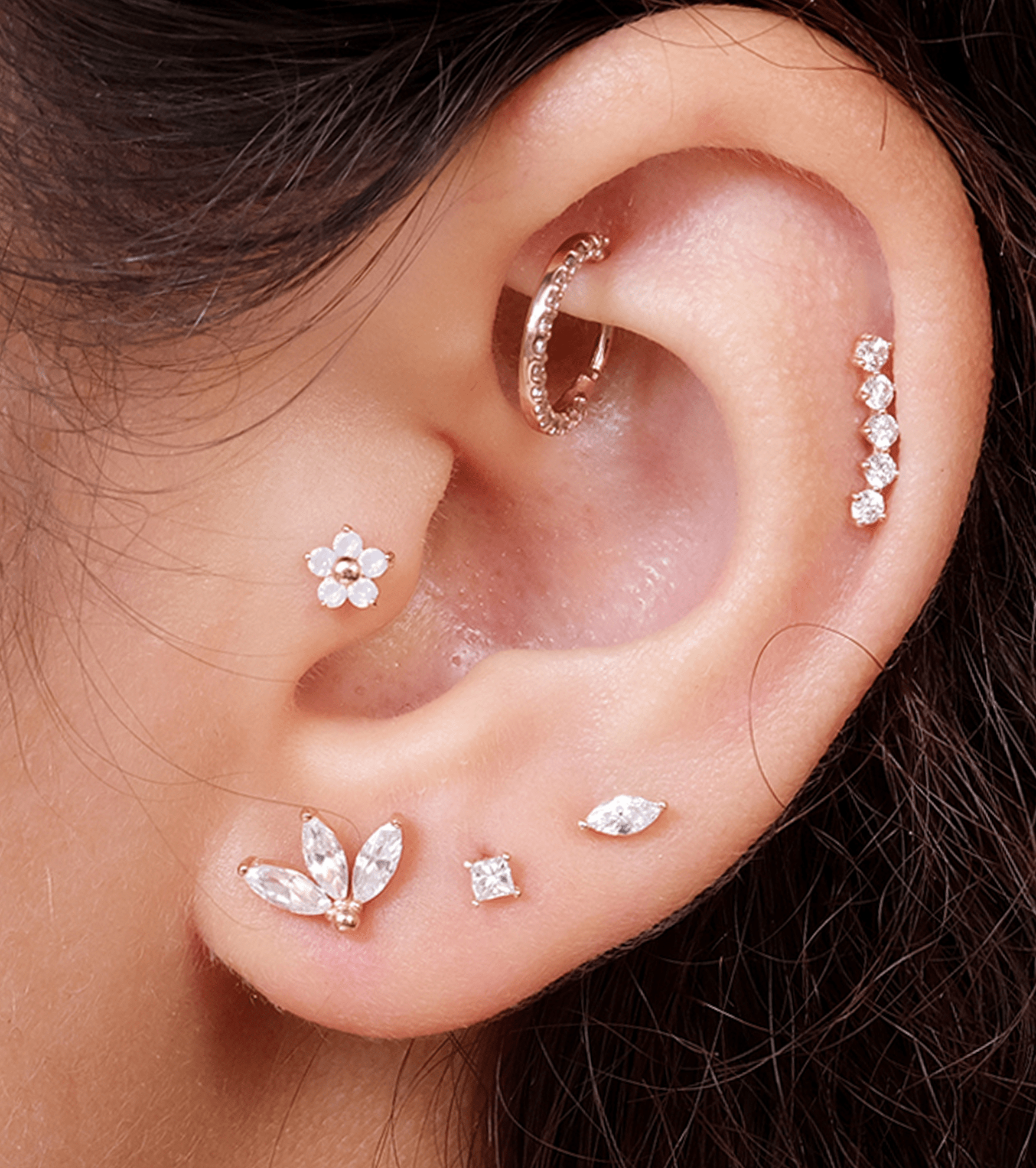 a close up of a person wearing a pair of ear piercings