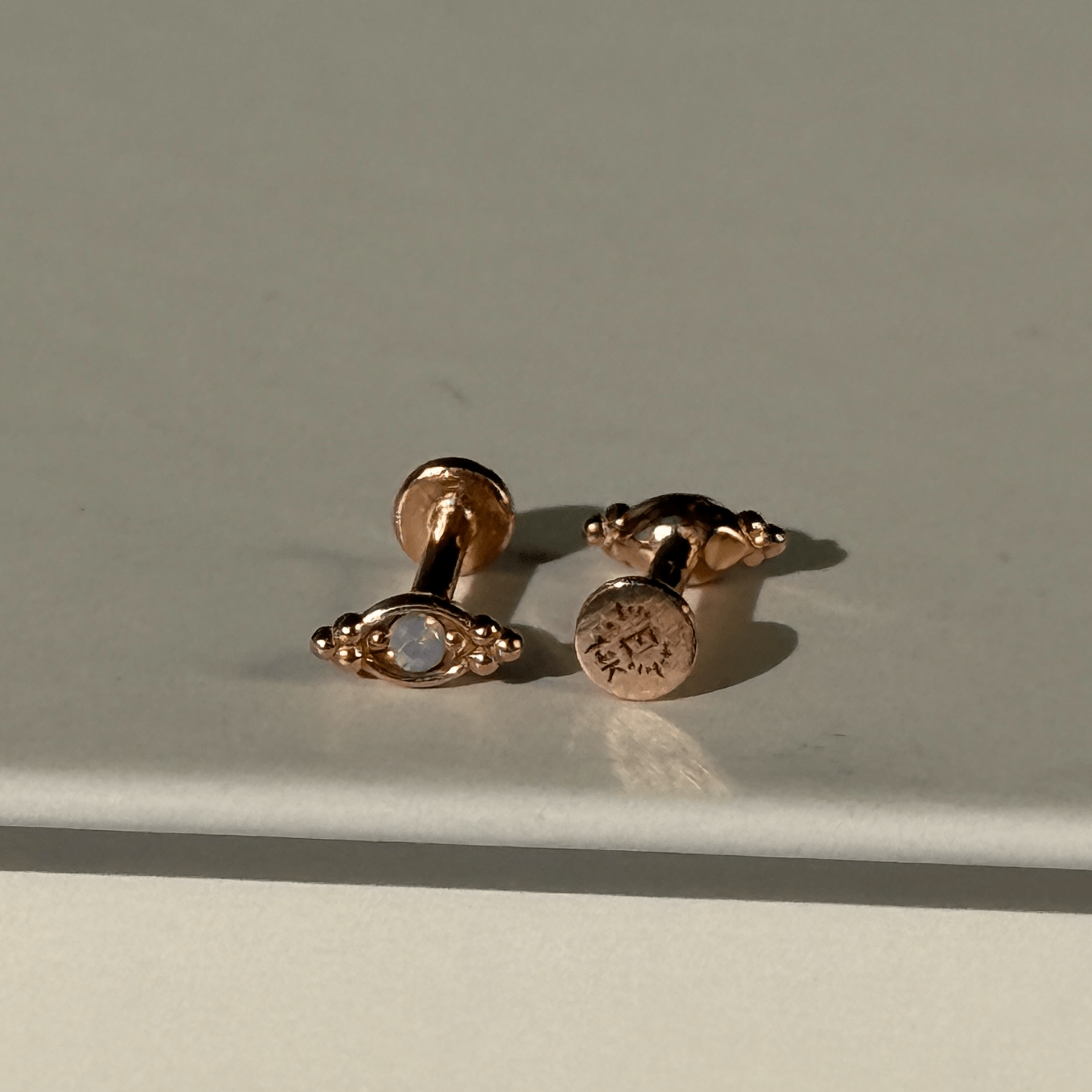 a pair of earrings sitting on top of a table