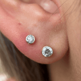 a close up of a person wearing a pair of ear piercings