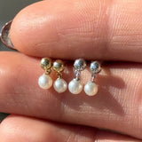 three pairs of pearl and gold earrings