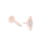 a pair of rose gold earrings with a diamond