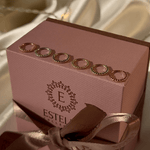 a pink box with a ribbon tied around it