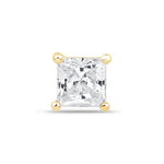 a princess cut diamond set in yellow gold