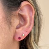 a close up of a person wearing a pair of ear piercings