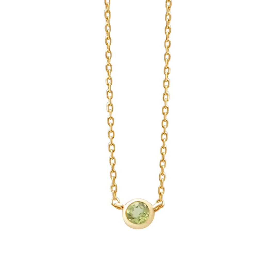 a yellow gold and peridot birthstone station necklace