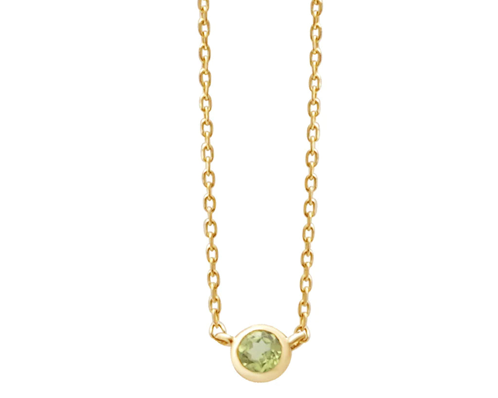 a yellow gold and peridot birthstone station necklace