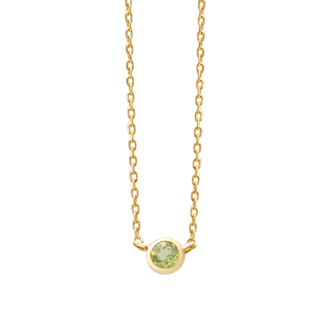 a yellow gold and peridot birthstone station necklace