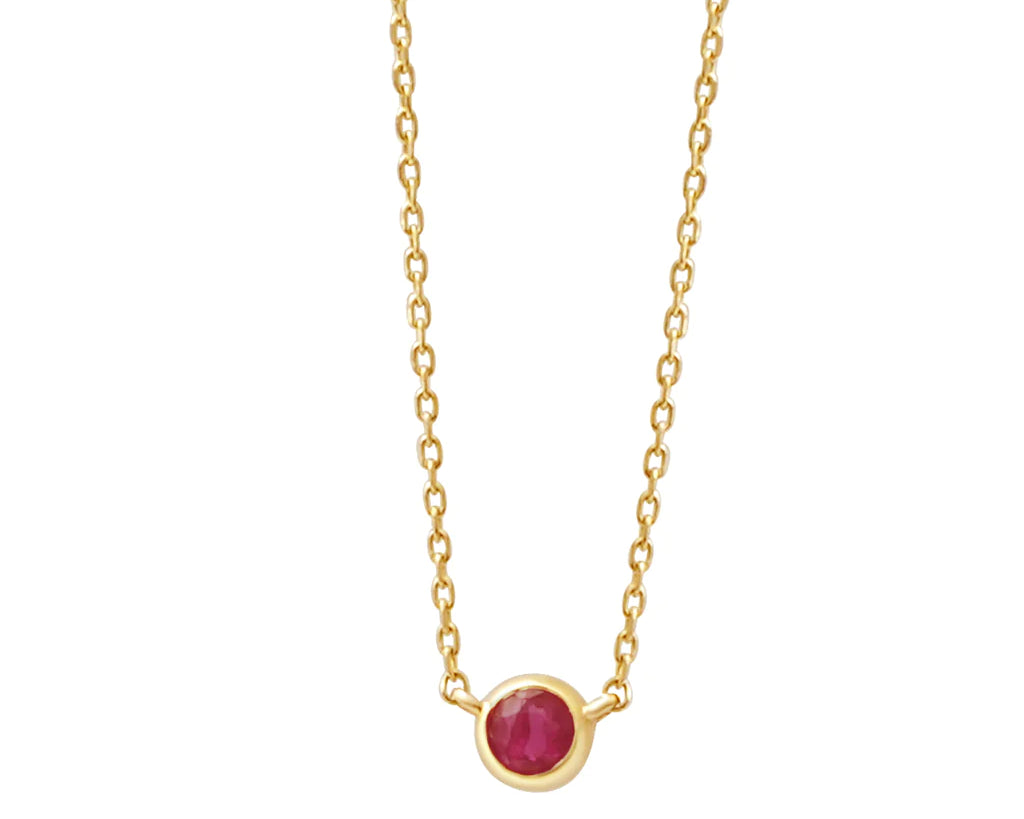 a yellow gold and ruby birthstone station necklace