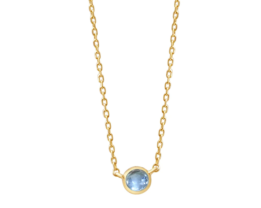 a yellow gold and topaz birthstone station necklace