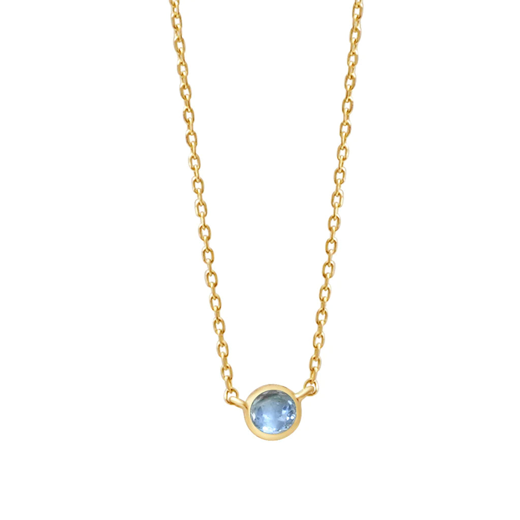 a yellow gold and topaz birthstone station necklace