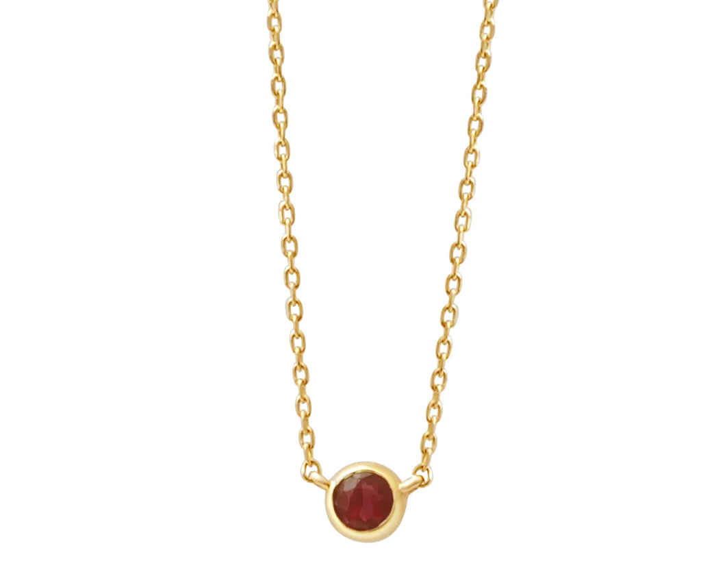 a yellow gold and garnet birthstone station necklace