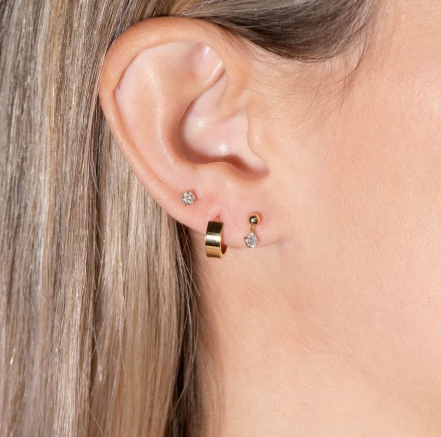 model wearing the diamond flat back stud along with other earrings