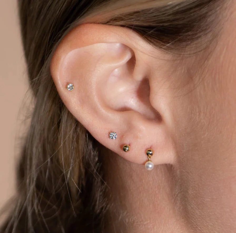 model wearing multiple carat sizes of the diamond flat back stud