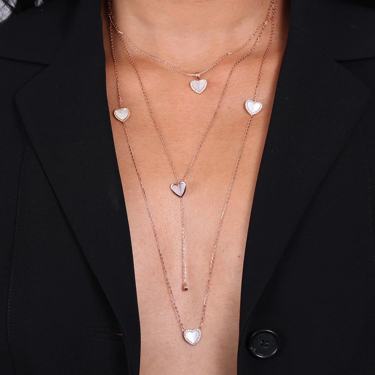 A woman wearing the Mother of Pearl Heart with Diamond Halo Pendant Necklace