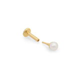 a pearl stud earring detached from its backing