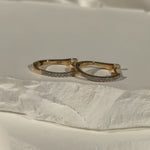 Tiny Diamond Huggie Hoops in 14k Yellow Gold