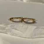 Tiny Diamond Huggie Hoops in 14k Yellow Gold