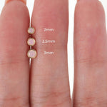 three different sizes of pink opal studs