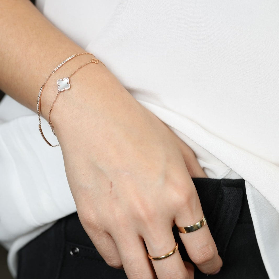 woman wearing rings and dainty diamond bracelets.